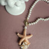 collana di perle con stella marina e corallo rosa