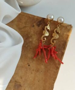 Statement earrings with gold seahorses and red coral cluster
