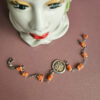bracciale a catena con corallo rosa e cammeo centrale con fiori dipinti a mano