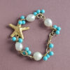 bracciale a catena con perle pasta di turchese e stella marina in ottone